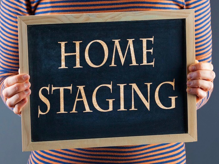 Hands holding chalkboard that reads home staging